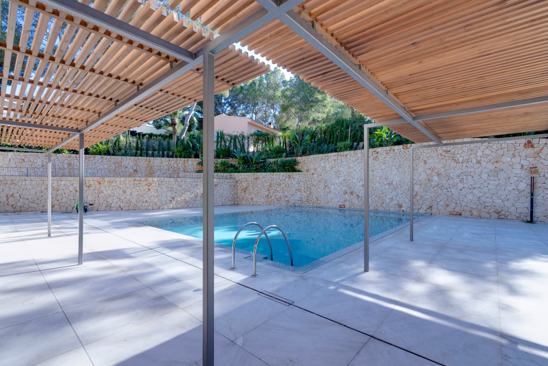 Outdoor pool under pergola