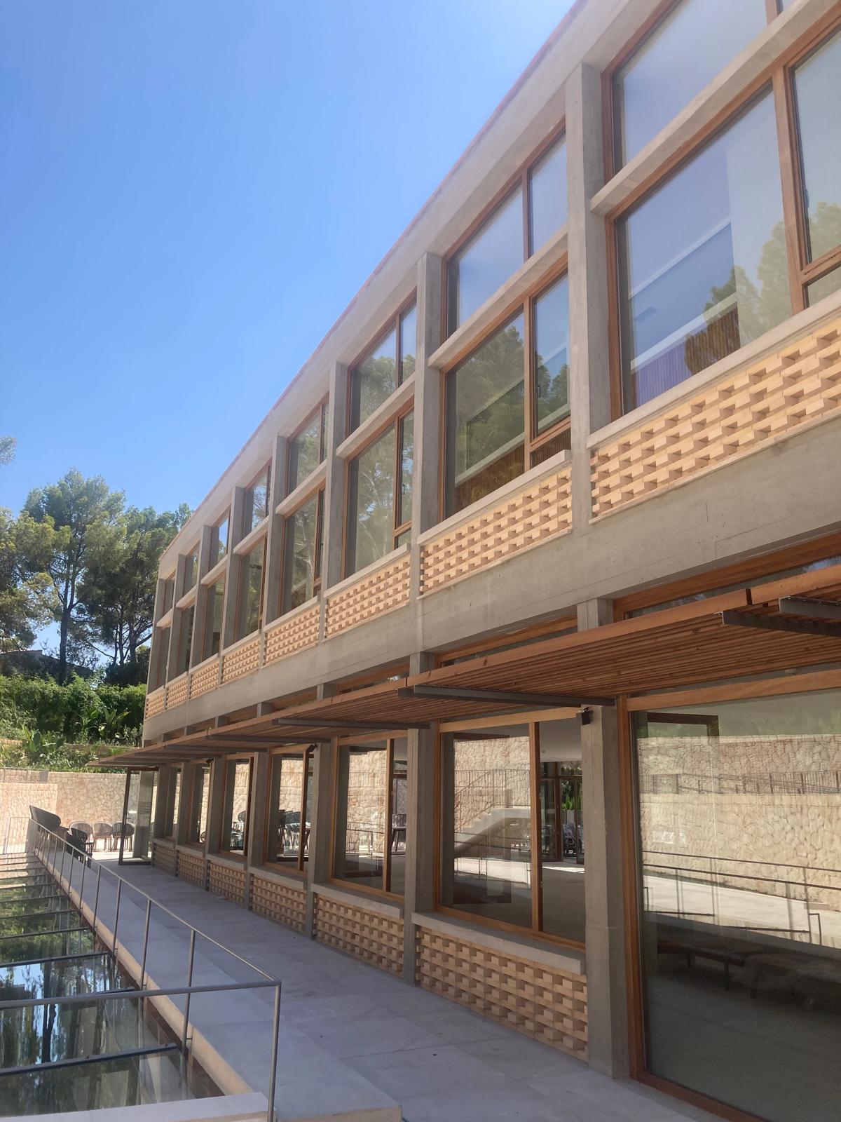 Stone and timber facade above reflecting pool